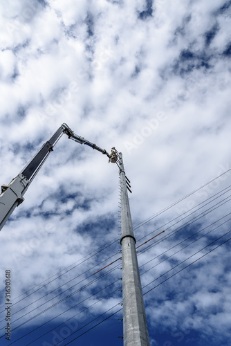 Bild auf Leinwand Fully Extended Huge Truck Mounted Crane Lift with an Operator in the Bucket at T