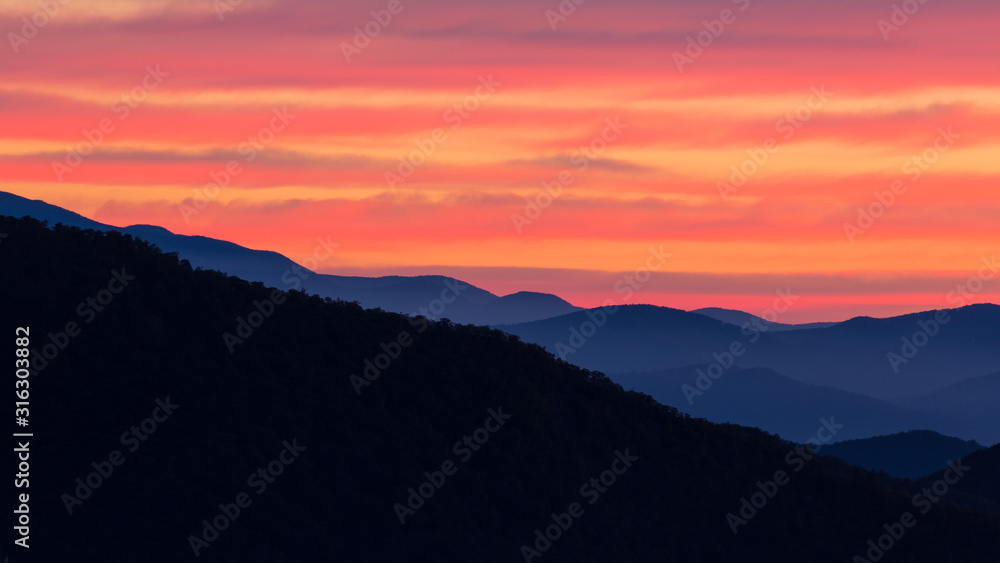 Bright colors of nautical sunrise over the Blue Ridge mountains