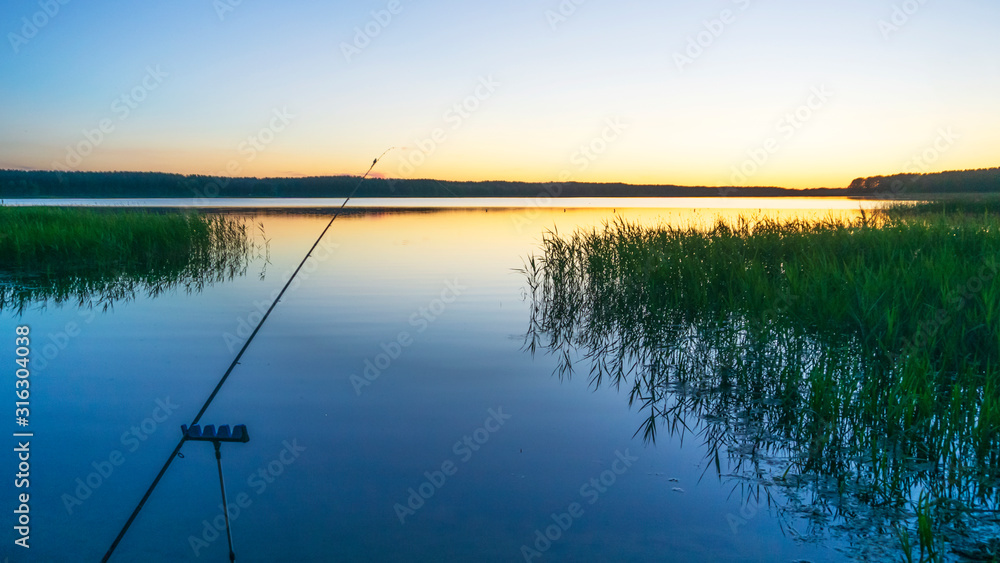 Fishing rod spinning with the line close-up. Relax and hobby concepts. Fishing rod spinning with the line close-up. Relax and hobby concepts.
