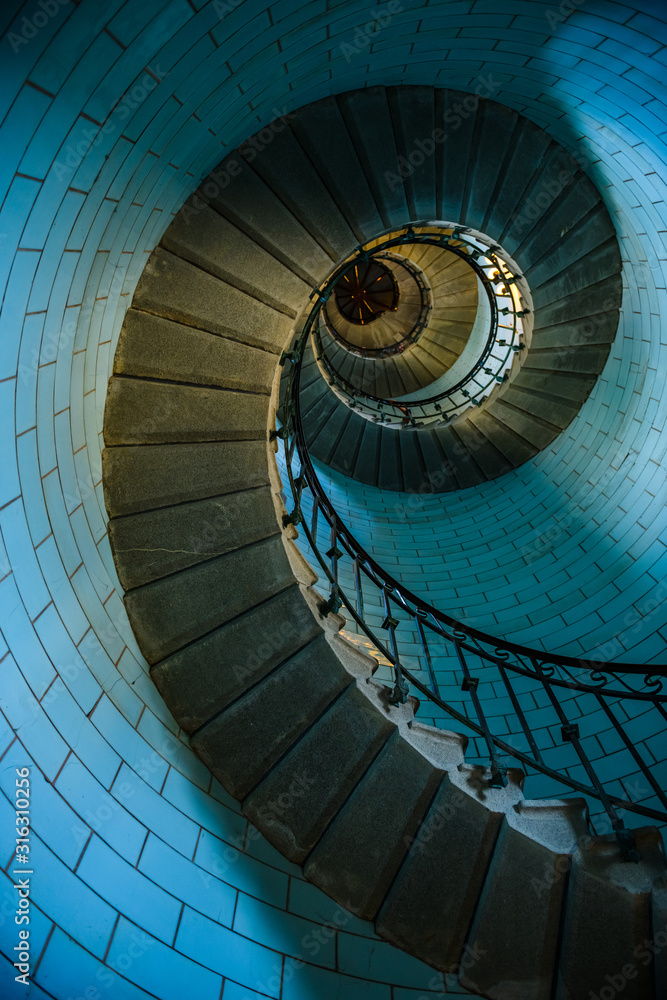 Fototapeta premium Beautiful spiral staircase to the top of Eckmuhl lighthouse, on the Penmarsh Peninsula. Brittany. France