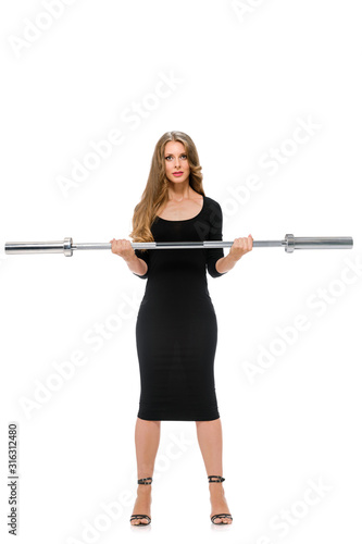 Fashion model with slim figure training with barbell on white background