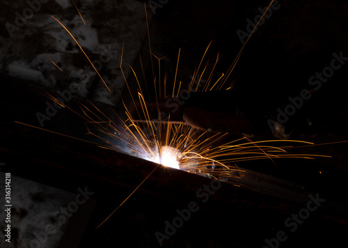 sparks from metal welding at a construction site