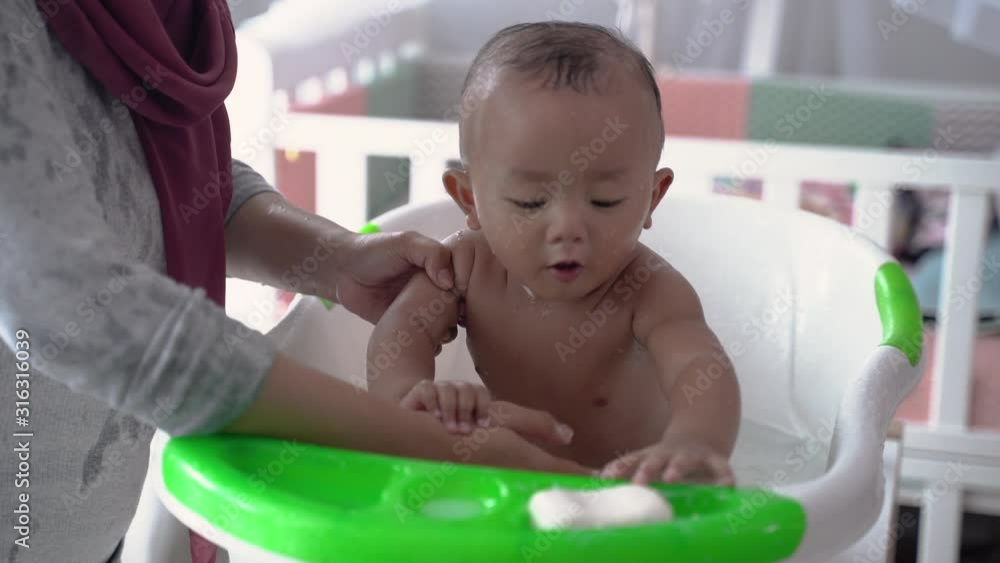 portrait of happy asian baby taking a bath with mother portrait of happy asian baby taking a bath with mother