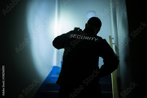 Security Guard Searching On Stairway