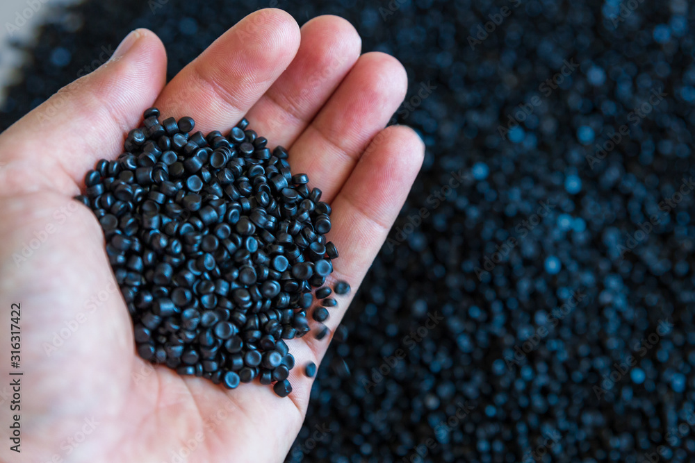 Close-up of plastic polymer granules. hand hold Polymer pellets. polymer plastic. compound polymer. Close-up of plastic polymer granules. hand hold Polymer pellets. polymer plastic. compound polymer.