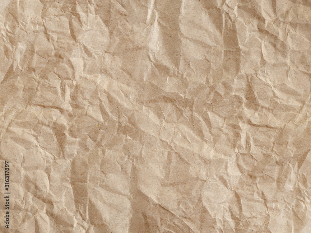 Textured crumpled beige paper craft background. Textured crumpled beige paper craft background.