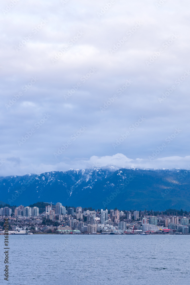 Naklejka premium View on Vancouver Downtown and Mountains over ocean. British Columbia. Canada.