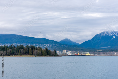 View on Vancouver Downtown and Mountains over ocean. British Columbia. Canada.