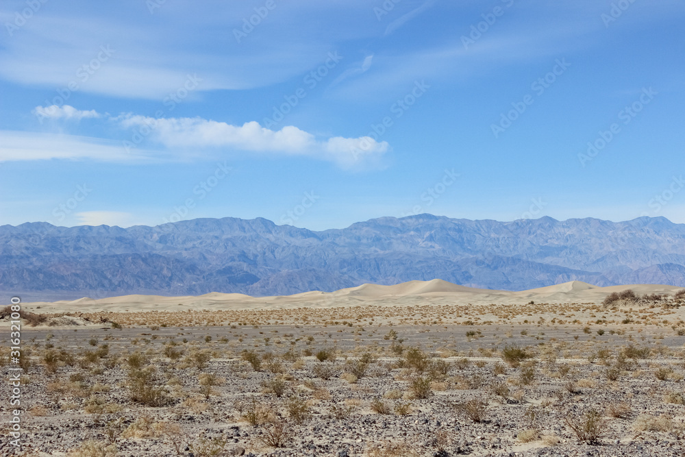 desert landscape with mountains and blue sky in Death Valley, California desert landscape with mountains and blue sky in Death Valley, California