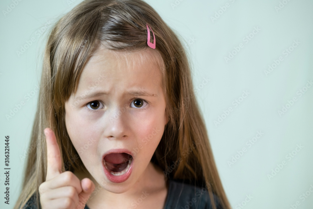 Close up portrait of angry shouting child girl looking aggressively in camera. Close up portrait of angry shouting child girl looking aggressively in camera.
