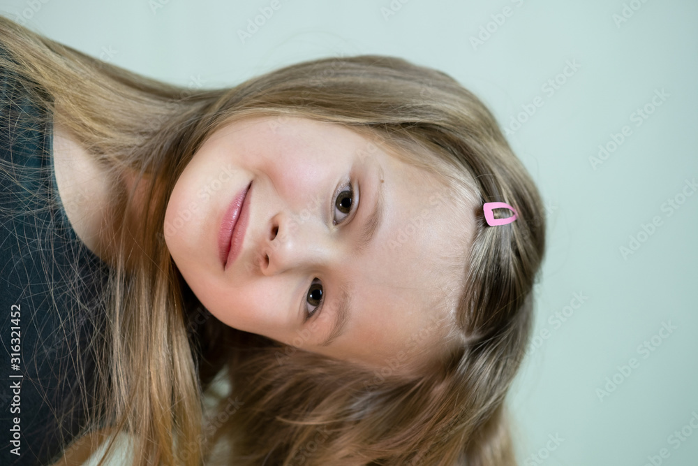 Close-up portrait of happy smiling little girl with long hair. Close-up portrait of happy smiling little girl with long hair.
