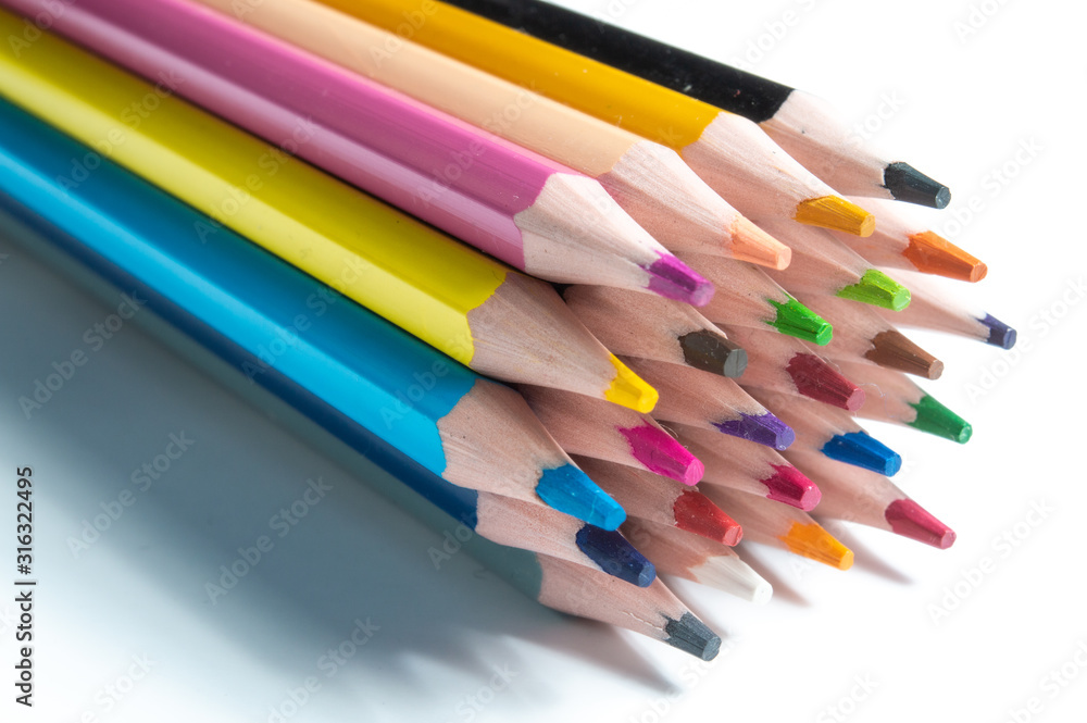 Fototapeta premium a stack of multi-colored pencils on a white background.
