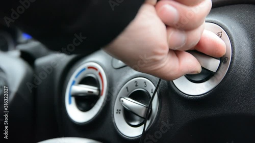 hand driver turn control button of air condition system in car.