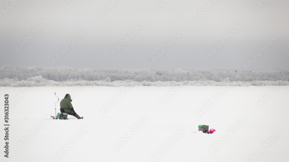 winter fishing on ice, natural background.Fishermen on the lake.