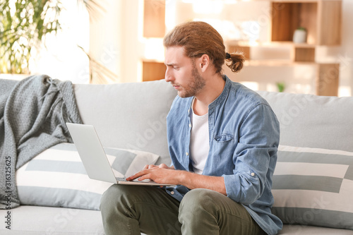 Handsome man with laptop on...