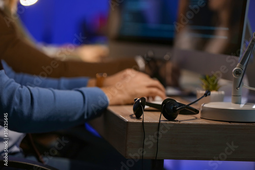 Headset on table of technical support agent at night