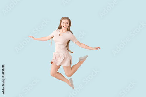 Jumping young woman on colo...
