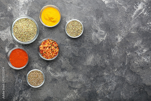 Many different spices on grey background
