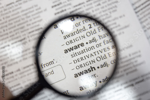 The word of phrase - aware - in a dictionary.