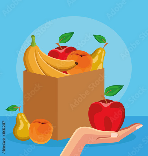 box with healthy fruits and hand holding a apple, colorful design
