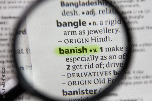 The word or phrase banish in a dictionary. photo