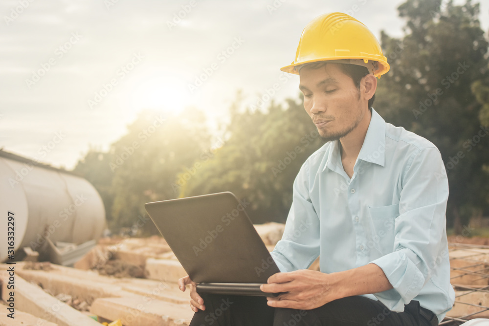 Engineering construction holding computer notebook inspection work at estate building project Engineering construction holding computer notebook inspection work at estate building project