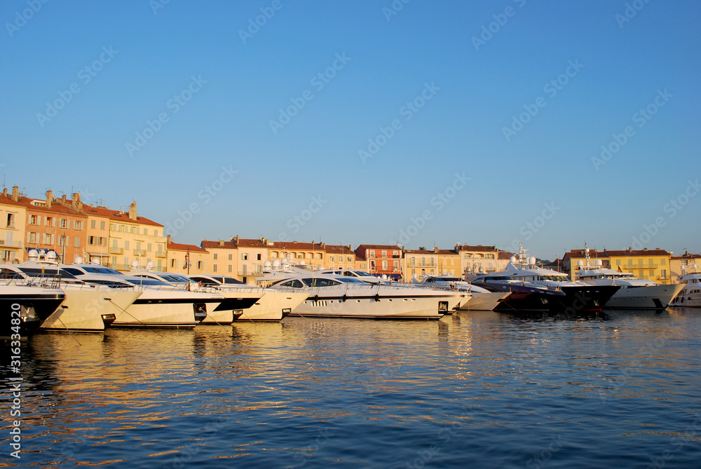 Yachts parked in the famous Saint-Tropez harbour on a nice summer evening