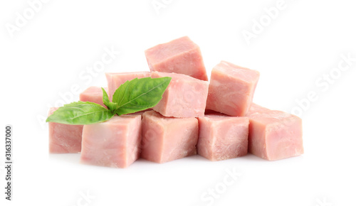 Cubes of tasty fresh ham with basil isolated on white