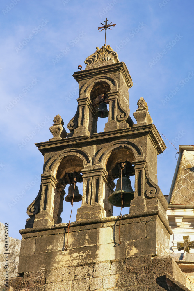 Religious architecture. Montenegro, Old Town of Kotor, UNESCO-World Heritage Site.  Bell tower of Church of St Luke against blue sky