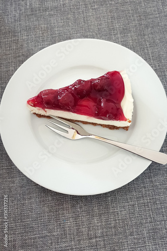 Slice of Cherry Monchou pie on plate with fork photo