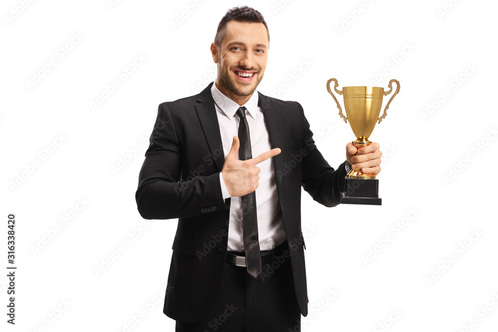 Businessman smiling and holding a golden trophy cup Businessman smiling and holding a golden trophy cup