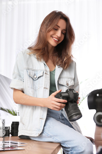 Professional photographer with camera working in light modern office