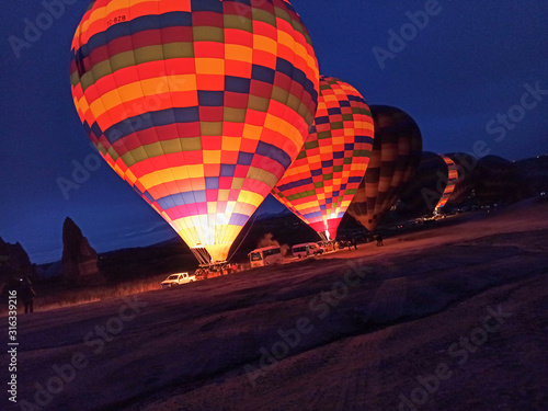Colorful Hot Air Balloons preparing to fly early morning in winter in Cappadocia, Turkey