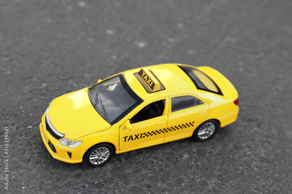 Yellow taxi car model on city street Yellow taxi car model on city street