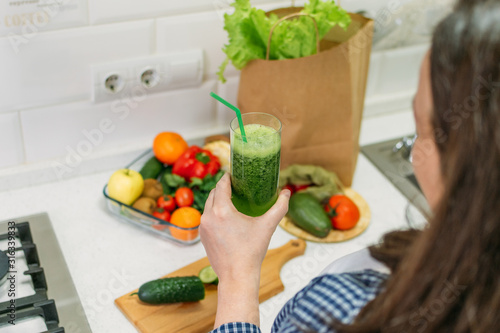 Green Smoothies for Weight Loss. Plus size woman holding in hand glass with slimming Green Smoothie, juice