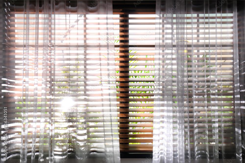 Window with beautiful curtains and blinds, closeup