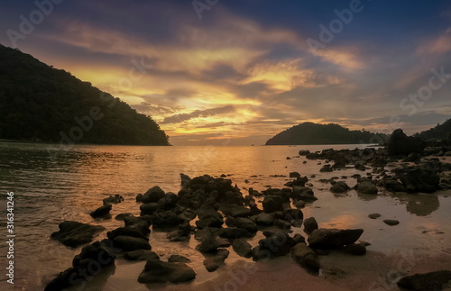 view seaside evening of many arch rocks in the sea with yellow sun light and cloudy sky background  sunset at Khao Chong Kad  Mu Ko Surin island  Phang Nga  southern of Thailand.