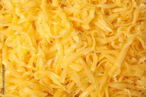 Delicious grated cheese as background, top view
