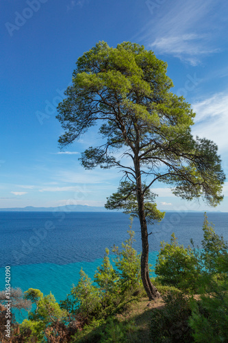 Amazing beautiful sea landscape of Greece. View from above at blue transparent sea water and clear sky. Vertical color photography.