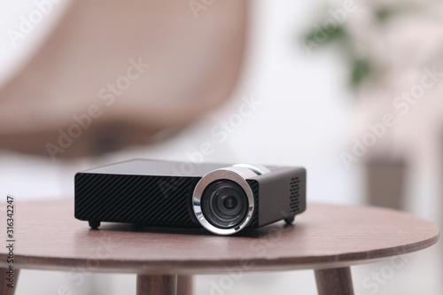 фотографія Modern video projector on wooden table indoors