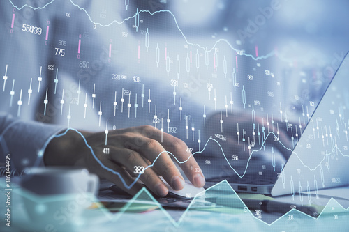 Double exposure of forex graph with man working on computer on background. Concept of market analysis.