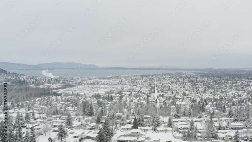 Aerial Above Snow Covered Town Along the Ocean Waterfront - Bellingham Washington USA Aerial Above Snow Covered Town Along the Ocean Waterfront - Bellingham Washington USA