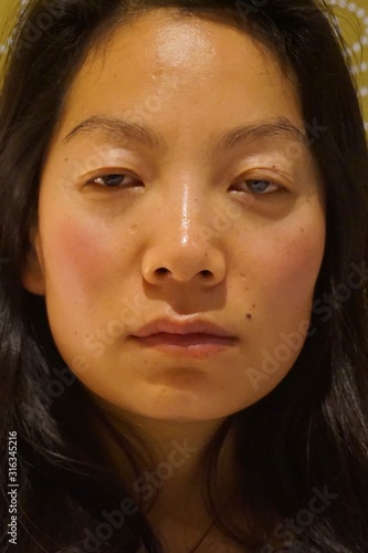 beautiful girl with good skin looking straight into the camera with a mysterious expression