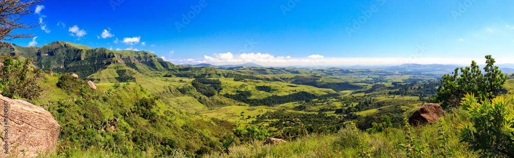 Panorama of a some mountains and a green and vast valley on a sunny day, Drakensberg, Giants Castle Game Reserve, South Africa