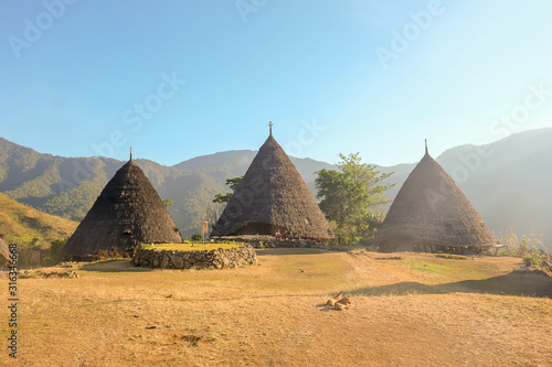 The authentic pyramid shaped houses in Wae Rebo village Indonesia photo