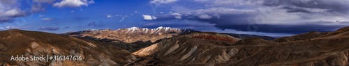 Wide angle panoramic view of the mountain peaks covered with snow © Vastram