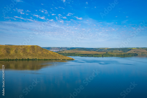 peaceful lake water hill land picturesque spring time scenery landscape nature reserve horizon view empty blue sky background copy space for your text here