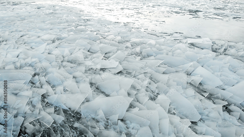 Aerial view of a frozen river. Fancy ice texture, cold chained water. Shards of ice stick out with sharp edges. Aerial view of a frozen river. Fancy ice texture, cold chained water. Shards of ice stick out with sharp edges.