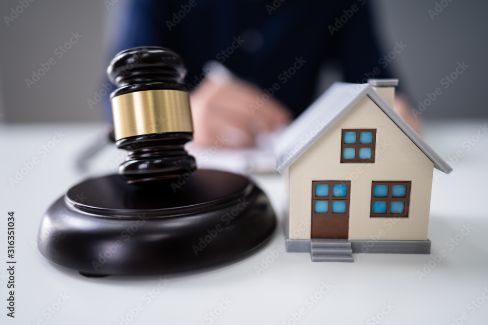 Judge Striking Gavel Near House Model Judge Striking Gavel Near House Model