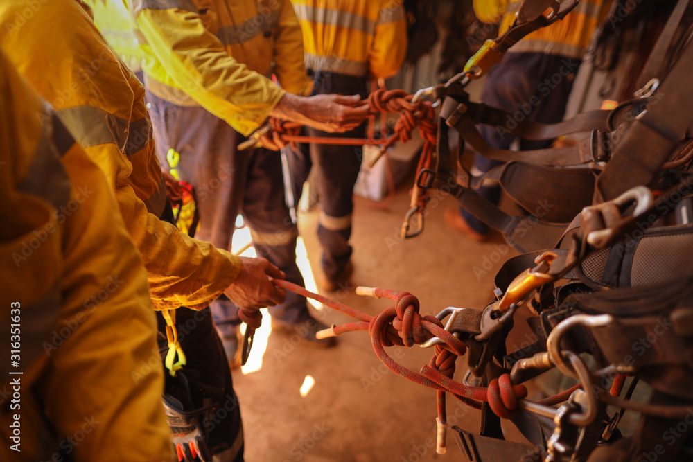 Industrial rope access technician inspector double checking inspecting ...